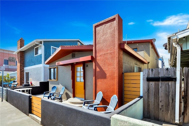 217 E Balboa Blvd, Newport Beach, CA 92661 - back of house with a chimney and stucco siding