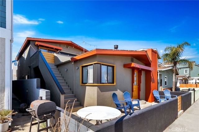 217 E Balboa Blvd, Newport Beach, CA 92661 - rear view of house with stucco siding and stairs