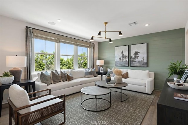 12247 Elliott Ave Unit F, El Monte, CA 91732 - living room with a chandelier, wood finished floors, wooden walls, and recessed lighting