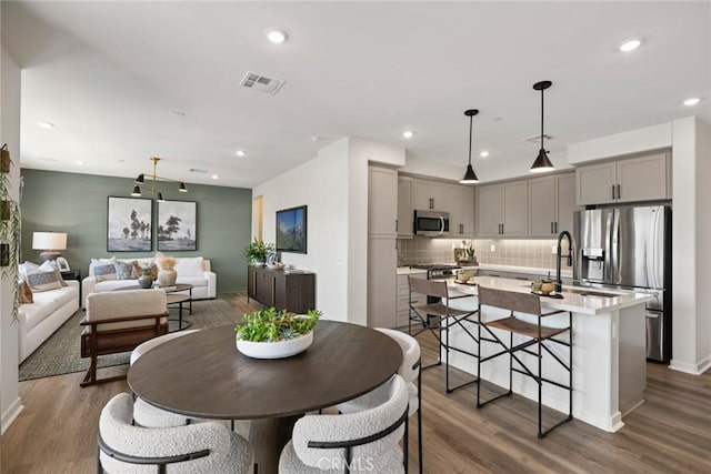12247 Elliott Ave Unit F, El Monte, CA 91732 - dining room featuring wood finished floors, recessed lighting, and an accent wall