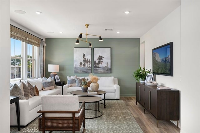 12247 Elliott Ave Unit F, El Monte, CA 91732 - living area featuring wood finished floors, recessed lighting, wooden walls, and a chandelier