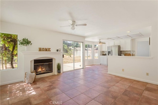 24249 Saradella Ct, Murrieta, CA 92562 - unfurnished living room featuring a ceiling fan and a glass covered fireplace