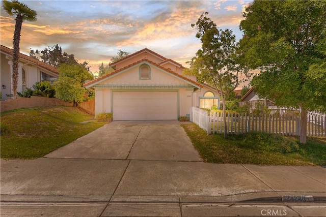 24249 Saradella Ct, Murrieta, CA 92562 - view of front of property with driveway, a fenced front yard, stucco siding, and a garage