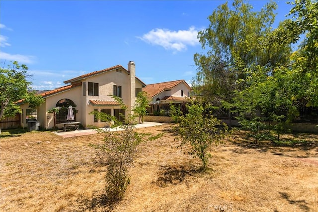 24249 Saradella Ct, Murrieta, CA 92562 - rear view of property featuring a tiled roof, a chimney, stucco siding, and a patio area