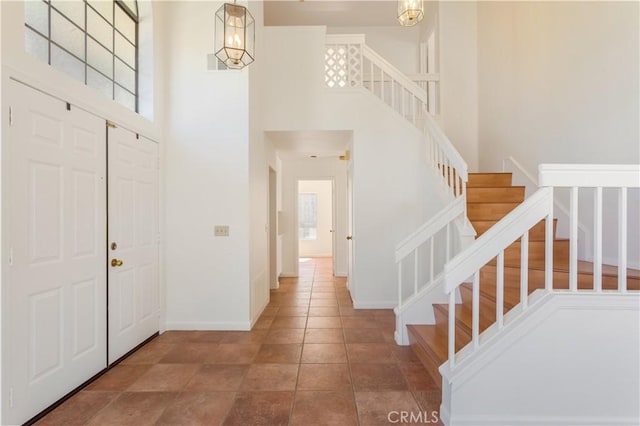 24249 Saradella Ct, Murrieta, CA 92562 - entrance foyer with a high ceiling, stairway, and healthy amount of natural light