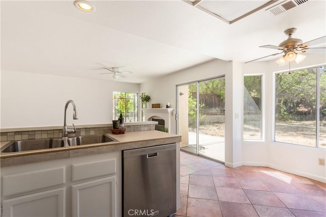 24249 Saradella Ct, Murrieta, CA 92562 - kitchen featuring stainless steel dishwasher, healthy amount of natural light, a ceiling fan, white cabinets, and recessed lighting