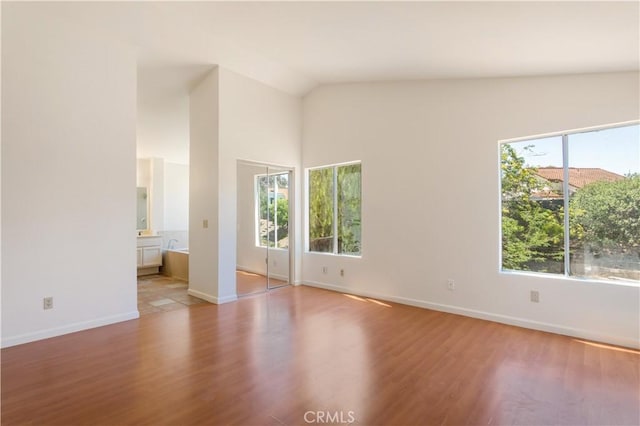 24249 Saradella Ct, Murrieta, CA 92562 - spare room featuring wood finished floors and vaulted ceiling