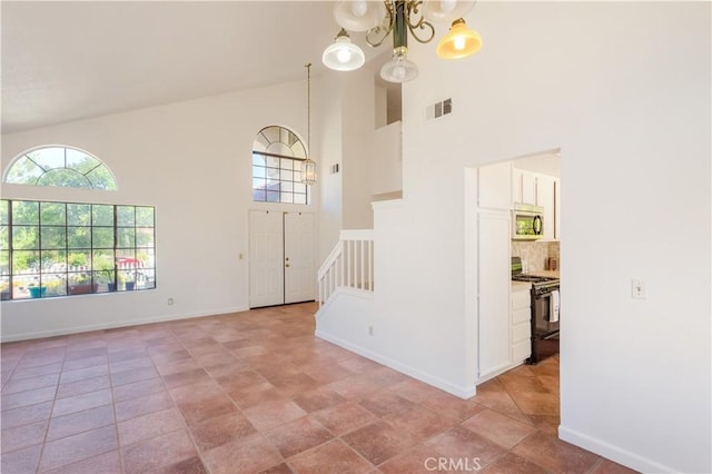 24249 Saradella Ct, Murrieta, CA 92562 - entryway with high vaulted ceiling, stairway, and a chandelier