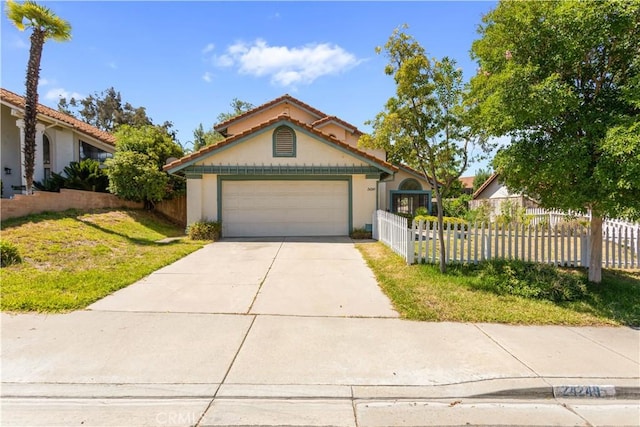 24249 Saradella Ct, Murrieta, CA 92562 - view of front facade featuring concrete driveway, a fenced front yard, stucco siding, and a garage