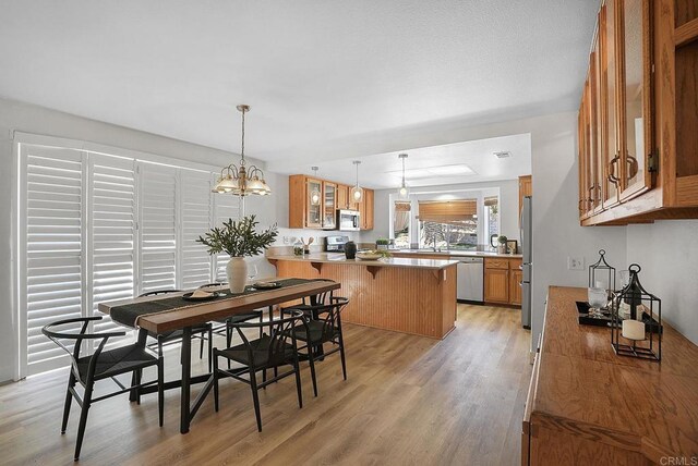 1930 Rosewood St, Vista, CA 92081 - dining room with light wood-style flooring and a chandelier