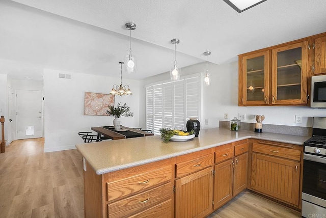 1930 Rosewood St, Vista, CA 92081 - kitchen featuring appliances with stainless steel finishes, a peninsula, brown cabinets, light wood finished floors, and glass insert cabinets