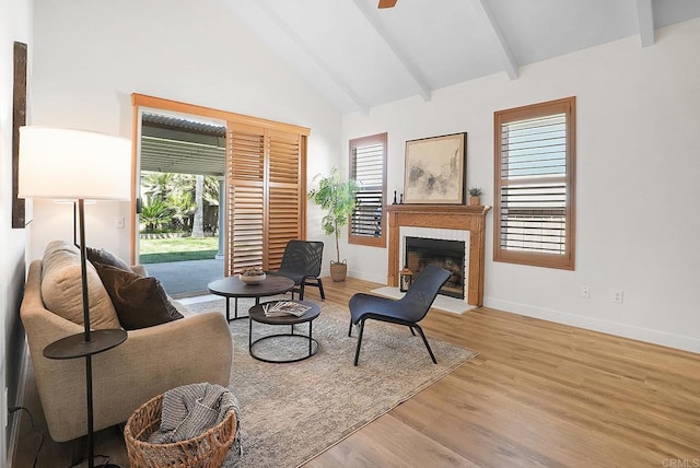 1930 Rosewood St, Vista, CA 92081 - living area featuring a fireplace with flush hearth, beamed ceiling, wood finished floors, a ceiling fan, and high vaulted ceiling