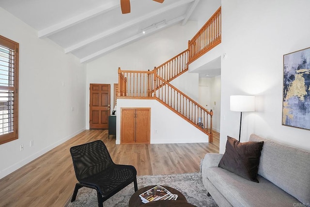 1930 Rosewood St, Vista, CA 92081 - living area featuring stairs, beamed ceiling, light wood finished floors, high vaulted ceiling, and plenty of natural light