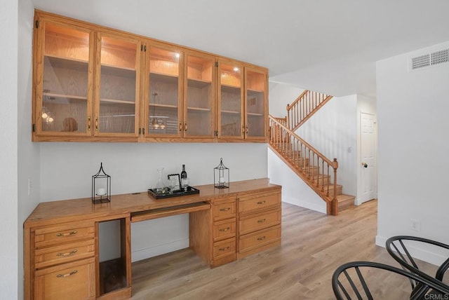 1930 Rosewood St, Vista, CA 92081 - bar area with light wood-style flooring, built in desk, and stairs