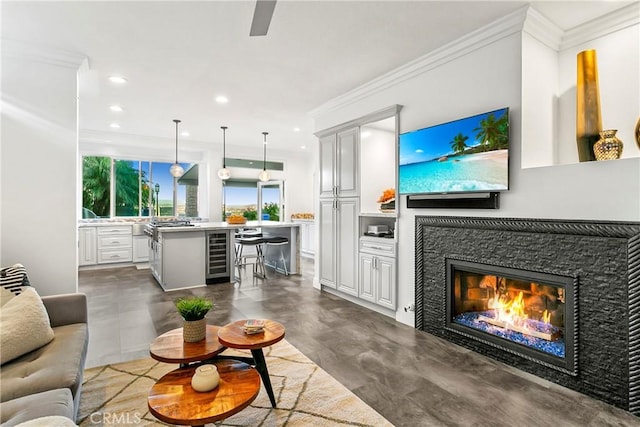 30282 Sonrisa, Laguna Niguel, CA 92677 - living room featuring a glass covered fireplace, recessed lighting, ornamental molding, and beverage cooler