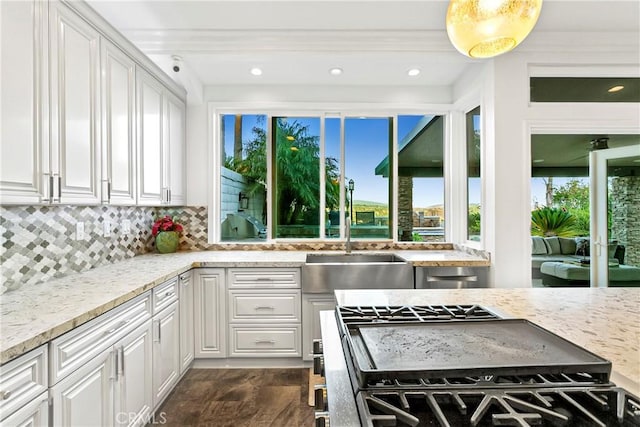 30282 Sonrisa, Laguna Niguel, CA 92677 - kitchen featuring white cabinetry, stainless steel range with gas stovetop, tasteful backsplash, light stone counters, and recessed lighting