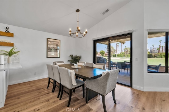 42386 Sultan Ave, Palm Desert, CA 92211 - dining room featuring a chandelier, light wood-style flooring, and high vaulted ceiling