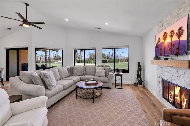 42386 Sultan Ave, Palm Desert, CA 92211 - living room featuring lofted ceiling, light wood finished floors, a ceiling fan, a fireplace, and plenty of natural light