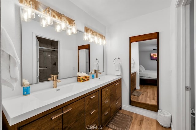 42386 Sultan Ave, Palm Desert, CA 92211 - full bathroom featuring double vanity, wood finished floors, a shower stall, and ensuite bath
