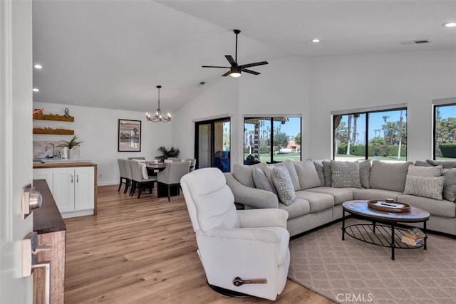 42386 Sultan Ave, Palm Desert, CA 92211 - living room featuring light wood-style flooring, a chandelier, recessed lighting, ceiling fan, and high vaulted ceiling