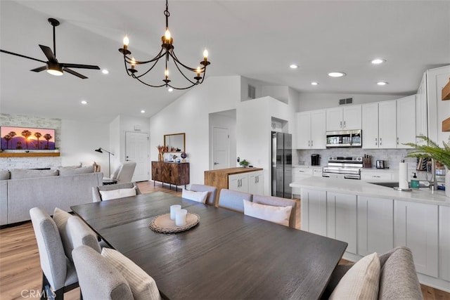 42386 Sultan Ave, Palm Desert, CA 92211 - dining area with vaulted ceiling, ceiling fan, recessed lighting, a chandelier, and light wood-style flooring
