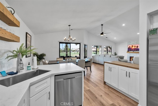 42386 Sultan Ave, Palm Desert, CA 92211 - kitchen featuring dishwasher, a peninsula, lofted ceiling, white cabinets, and light wood-style floors