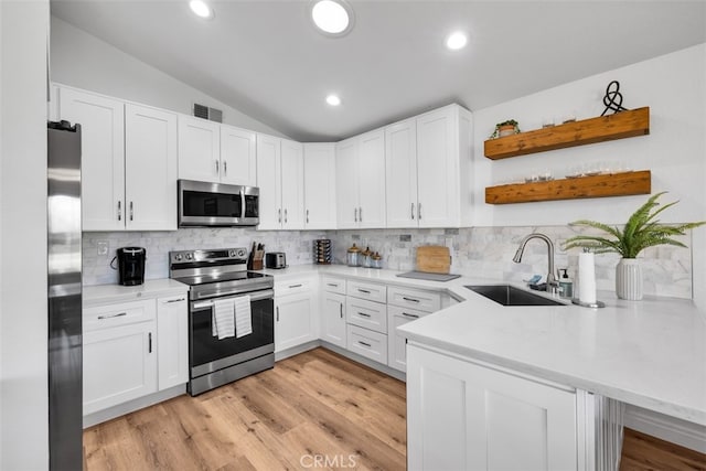 42386 Sultan Ave, Palm Desert, CA 92211 - kitchen featuring appliances with stainless steel finishes, open shelves, white cabinets, vaulted ceiling, and recessed lighting