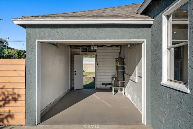 14712 Helwig Ave, Norwalk, CA 90650 - property entrance with gas water heater, stucco siding, a garage, and a patio