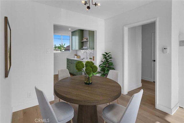 14712 Helwig Ave, Norwalk, CA 90650 - dining space featuring light wood-style floors and a chandelier