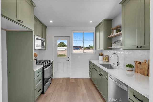 14712 Helwig Ave, Norwalk, CA 90650 - kitchen featuring green cabinetry, stainless steel appliances, open shelves, backsplash, and recessed lighting