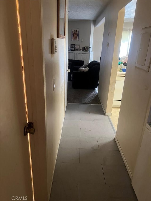 1025 N Tippecanoe Ave Unit 238, San Bernardino, CA 92410 - corridor featuring a textured ceiling and baseboards