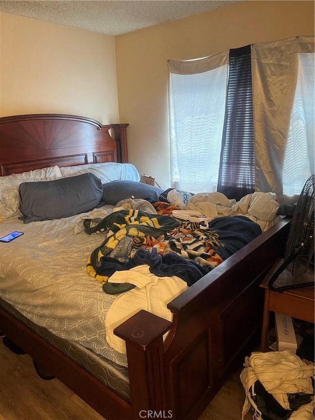 1025 N Tippecanoe Ave Unit 238, San Bernardino, CA 92410 - bedroom featuring a textured ceiling and wood finished floors