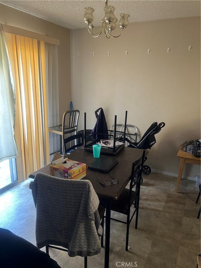 1025 N Tippecanoe Ave Unit 238, San Bernardino, CA 92410 - dining area with a textured ceiling and a chandelier