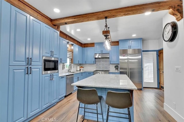 10784 Cole Way, Grass Valley, CA 95945 - kitchen featuring built in appliances, blue cabinets, a breakfast bar, light wood finished floors, and recessed lighting