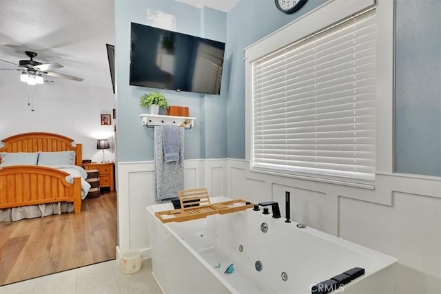 10784 Cole Way, Grass Valley, CA 95945 - ensuite bathroom with a whirlpool tub, a wainscoted wall, a ceiling fan, a decorative wall, and tile patterned floors