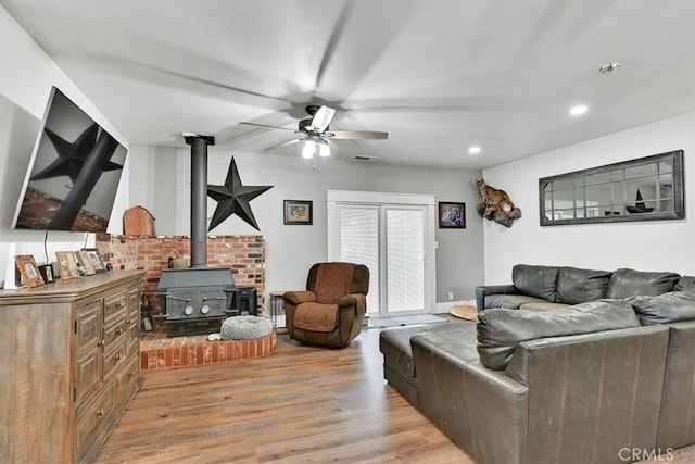 10784 Cole Way, Grass Valley, CA 95945 - living area featuring a wood stove, a ceiling fan, light wood-style flooring, and recessed lighting