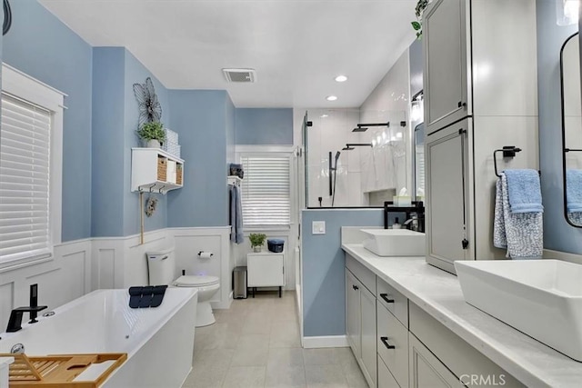 10784 Cole Way, Grass Valley, CA 95945 - bathroom with a shower stall, a freestanding tub, double vanity, a wainscoted wall, and recessed lighting