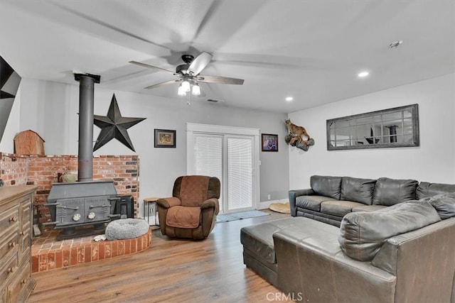 10784 Cole Way, Grass Valley, CA 95945 - living area featuring a wood stove, wood finished floors, a ceiling fan, and recessed lighting