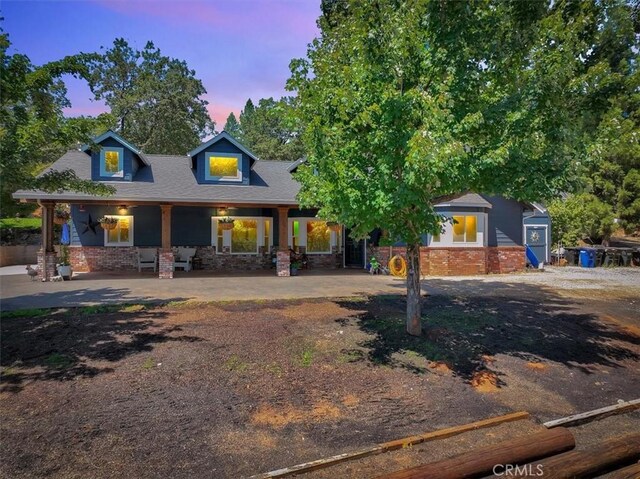 10784 Cole Way, Grass Valley, CA 95945 - view of front of home with brick siding, covered porch, and a shingled roof