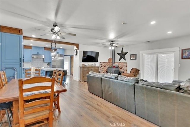 10784 Cole Way, Grass Valley, CA 95945 - living room featuring ceiling fan, recessed lighting, light wood-style floors, and a wood stove
