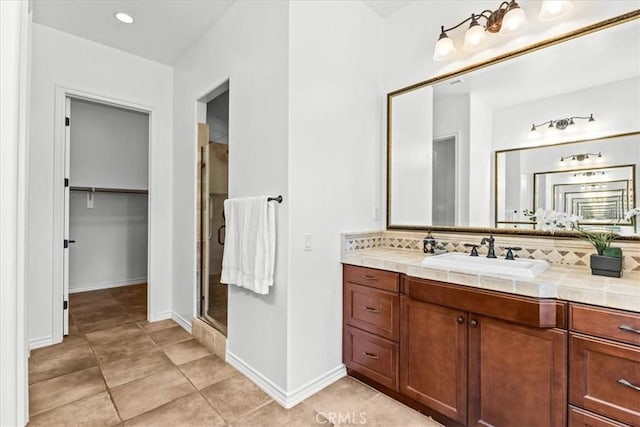 31521 Paseo Campeon, San Juan Capistrano, CA 92675 - full bath featuring a stall shower, vanity, tasteful backsplash, a spacious closet, and tile patterned flooring