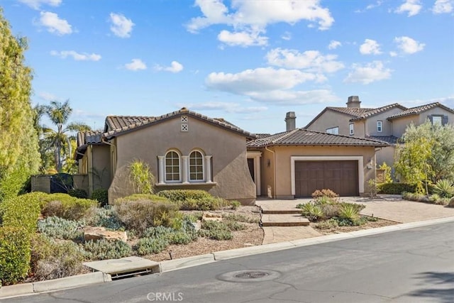 31521 Paseo Campeon, San Juan Capistrano, CA 92675 - mediterranean / spanish-style home with an attached garage, stucco siding, a tiled roof, driveway, and a chimney