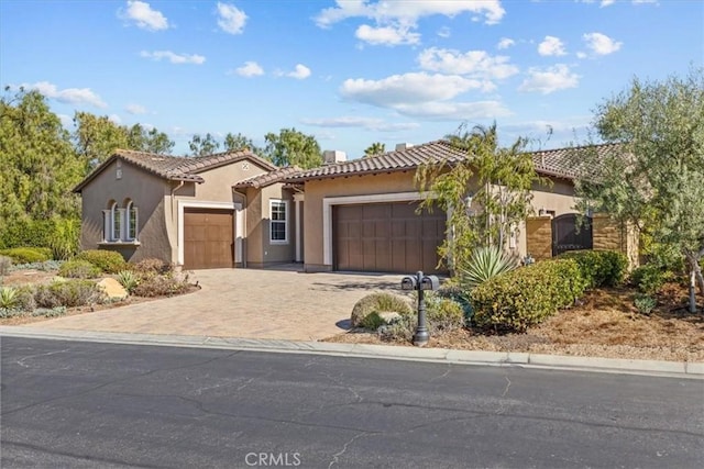 31521 Paseo Campeon, San Juan Capistrano, CA 92675 - mediterranean / spanish home featuring an attached garage, a tiled roof, stucco siding, and driveway