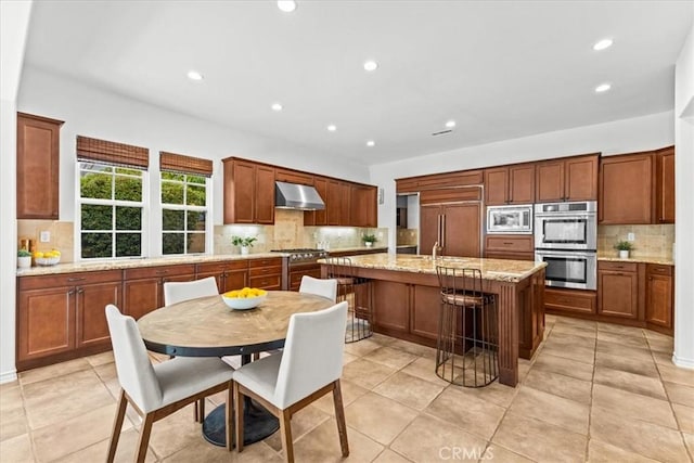 31521 Paseo Campeon, San Juan Capistrano, CA 92675 - kitchen featuring built in appliances, decorative backsplash, wall chimney exhaust hood, recessed lighting, and a kitchen island with sink
