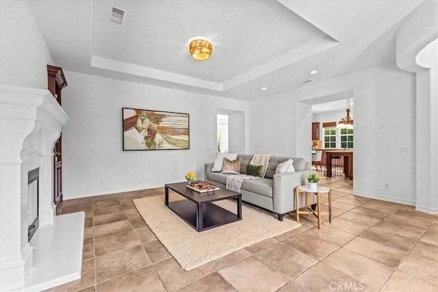 31521 Paseo Campeon, San Juan Capistrano, CA 92675 - living room with a tray ceiling, a fireplace with raised hearth, and recessed lighting