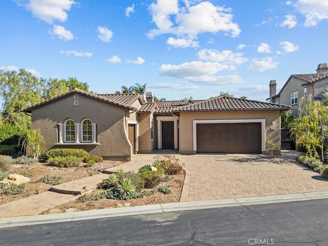 31521 Paseo Campeon, San Juan Capistrano, CA 92675 - view of front of house with a tiled roof, stucco siding, a garage, and decorative driveway