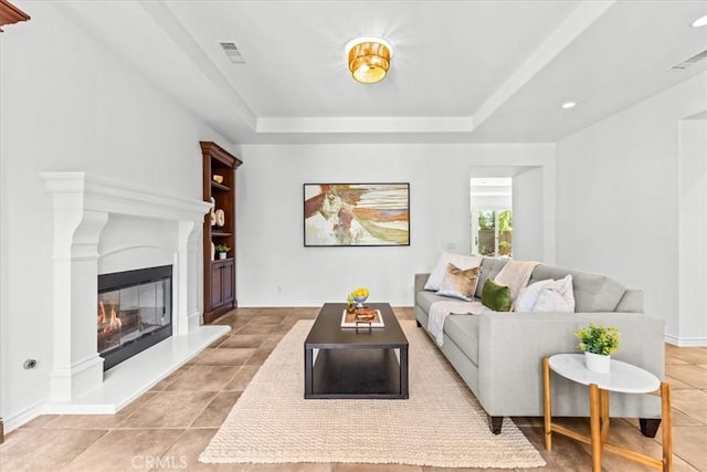31521 Paseo Campeon, San Juan Capistrano, CA 92675 - living room featuring a glass covered fireplace, light tile patterned floors, recessed lighting, and a tray ceiling
