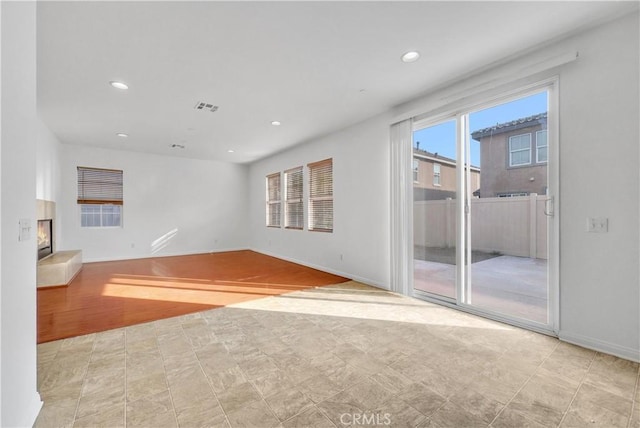4564 Vincent Way, Riverside, CA 92501 - spare room featuring recessed lighting, a glass covered fireplace, and tile patterned floors
