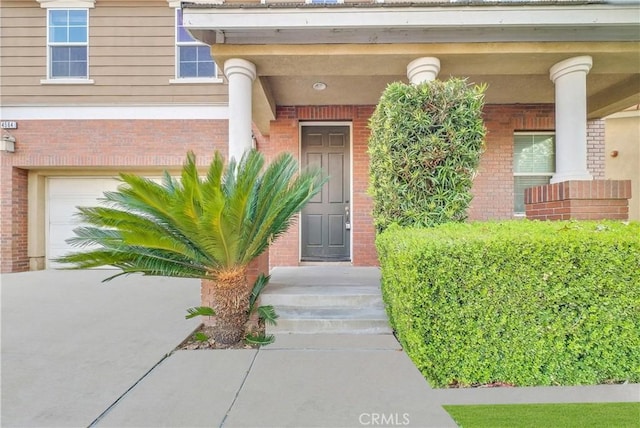 4564 Vincent Way, Riverside, CA 92501 - doorway to property featuring brick siding and an attached garage