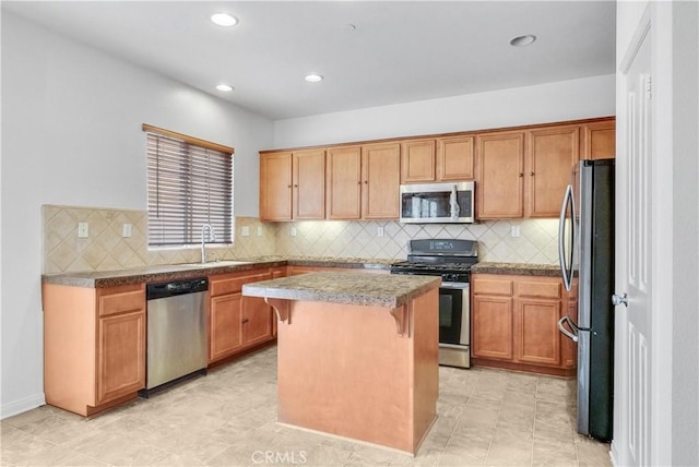 4564 Vincent Way, Riverside, CA 92501 - kitchen featuring appliances with stainless steel finishes, a kitchen bar, decorative backsplash, recessed lighting, and a kitchen island